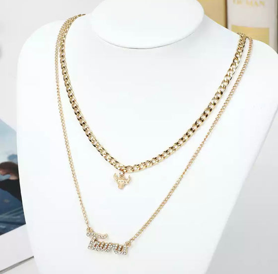 gold diamond taurus zodiac necklace set.